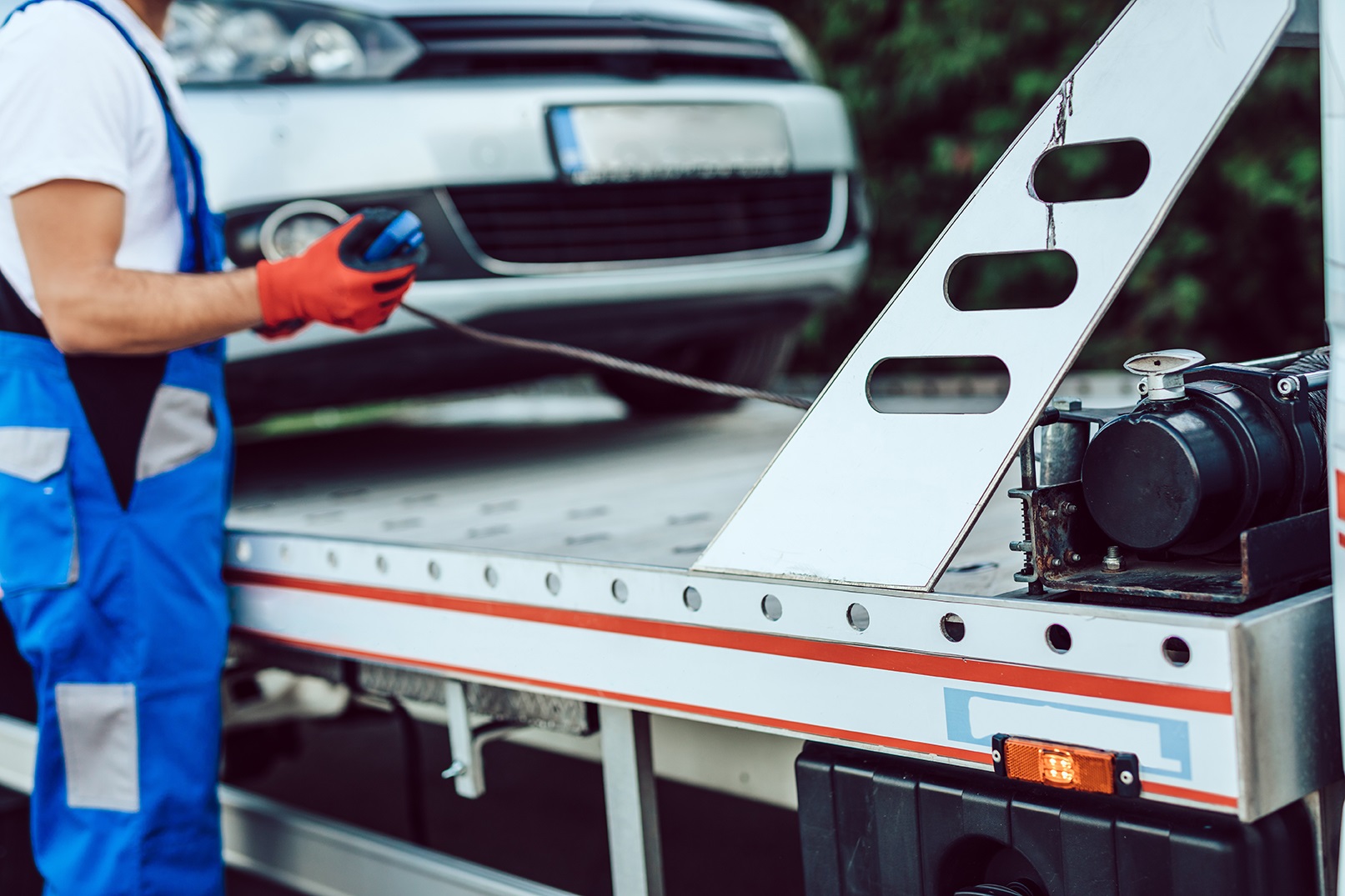 Handsome middle age man working in towing service on the road. R