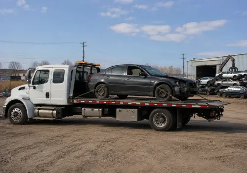Scrap car being collected by a tow truck in Calgary