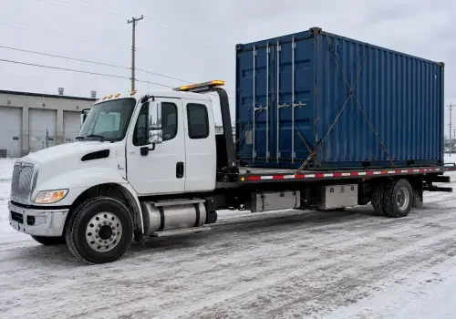 Flatbed truck transporting a sea container in Calgary