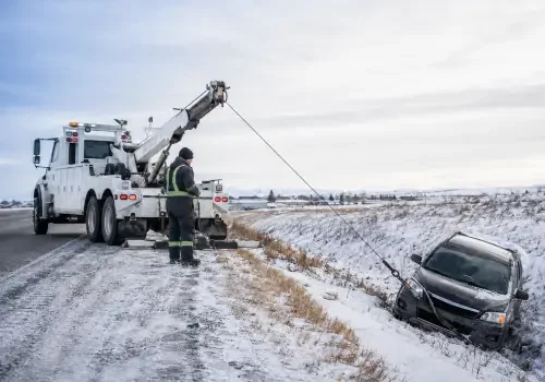 Wrecker recovering a vehicle stuck in snow near Calgary